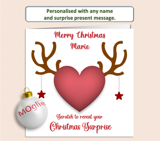 Christmas card having a scratch to reveal panel with reindeer antlers hiding details of a surprise present.
