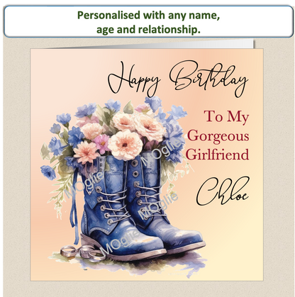 birthday card of walking boot filled with colourful flowers and elegant scroll text