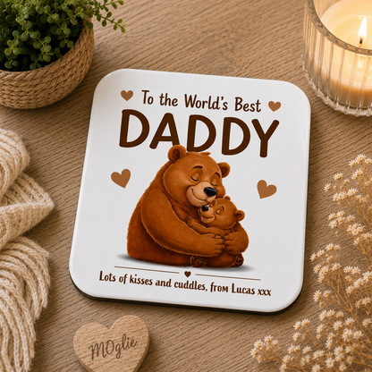 Coaster with bear illustration and text 'To the World's Best Daddy' on a wooden surface.