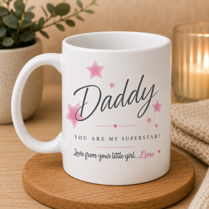White mug with 'Daddy, you are my superstar! Love from your little girl...' text on a wooden coaster.