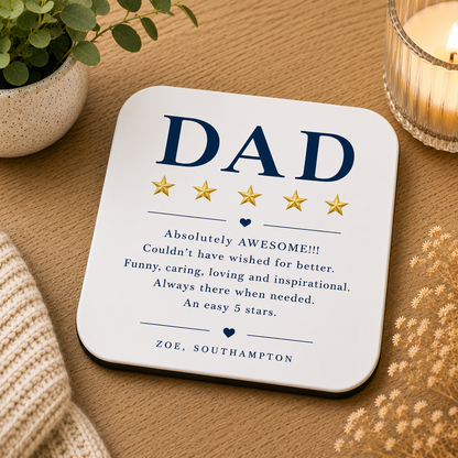 Coaster with 'DAD' and five-star rating on a wooden surface with a plant and candle.