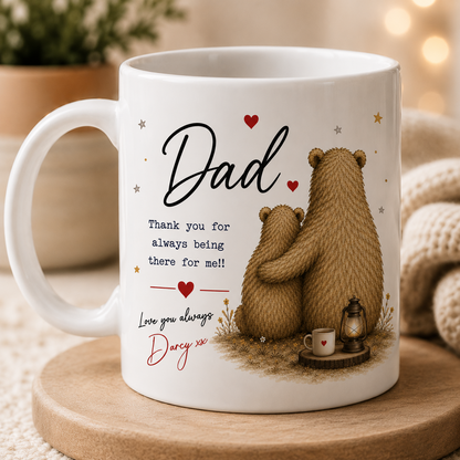 White mug with bear design and personalized message on a wooden coaster.