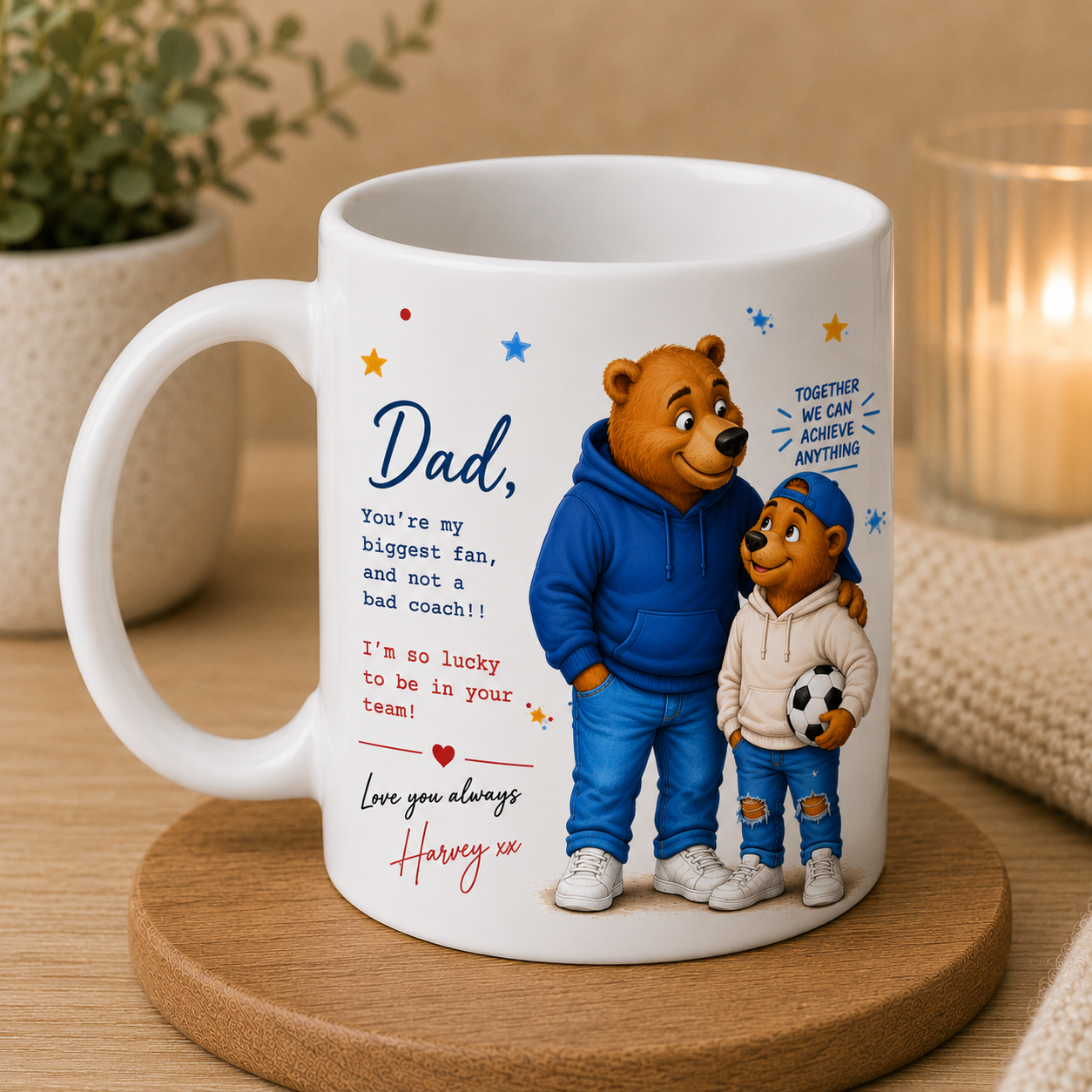 White mug with cartoon dad and young boy bears, with a football, and a message on a wooden coaster.