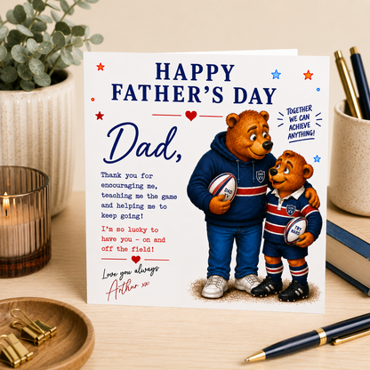 Father's Day card with two bears holding rugby balls on a desk with stationery items.