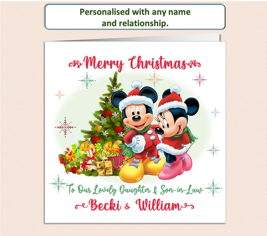 Mickey & Minnie in Christmas suits next to a Christmas Tree