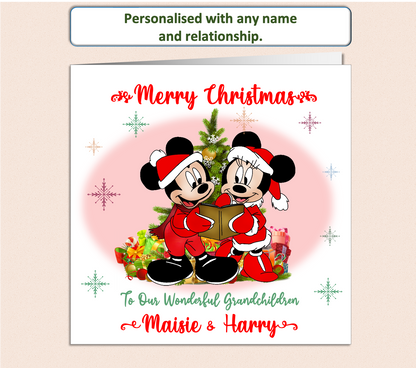 Mickey and Minnie Mouse dressed in a Christmas outfit next to a Christmas Tree